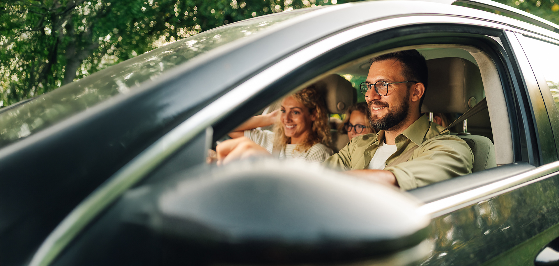 Family smiling in a car